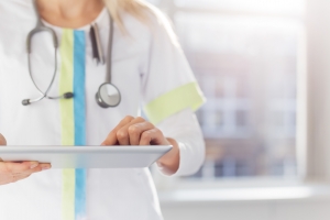 Female doctor using ipad while working in hospital