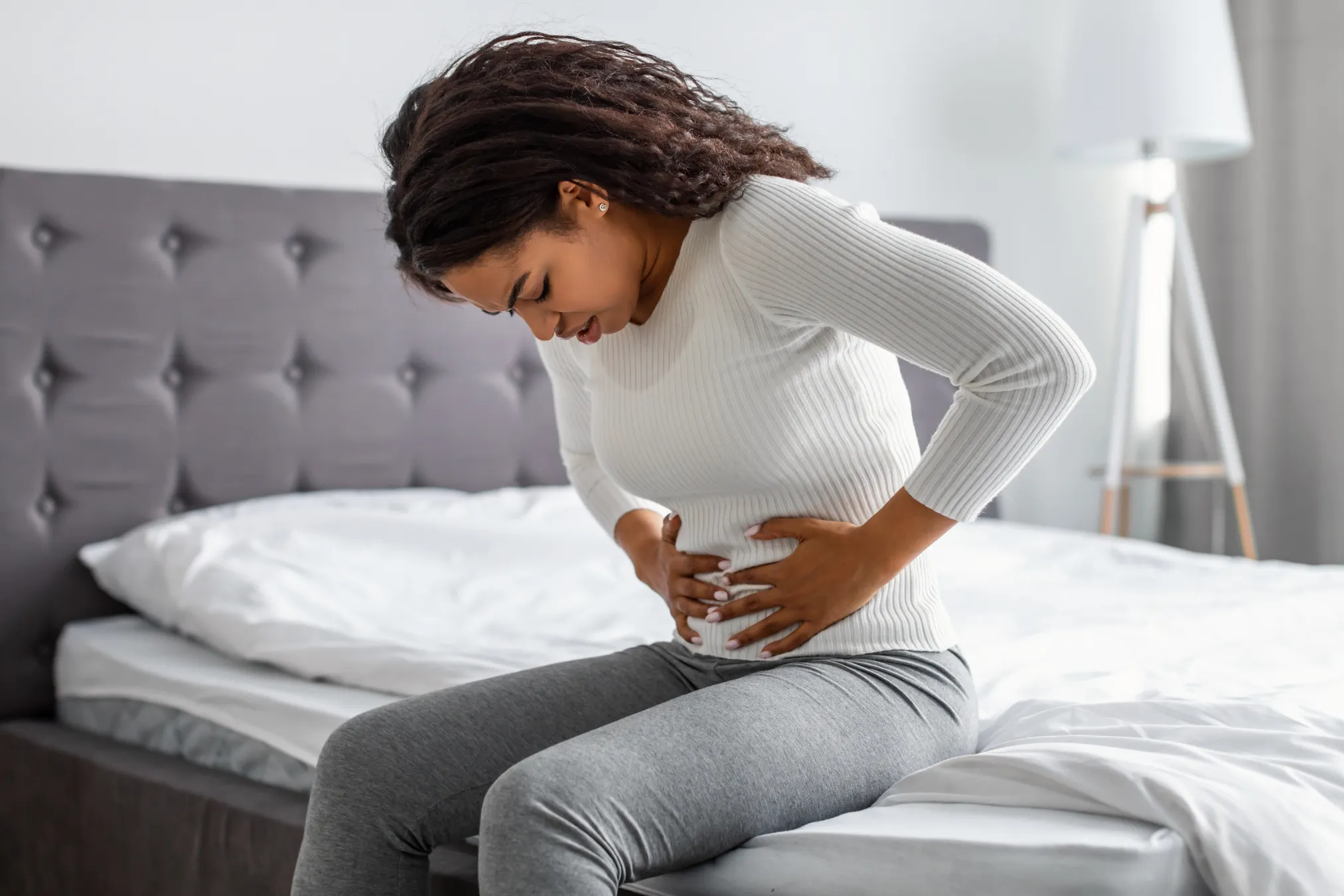 Woman holding her stomach area