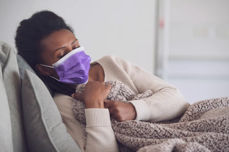 Woman laying down with face mask on